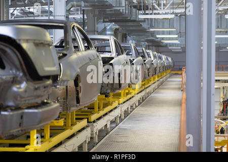 body of car on conveyor Modern Assembly of cars at plant. automated build process of car body