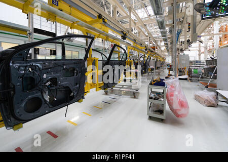 car door on conveyor. Robotic equipment makes Assembly of car. Modern car Assembly at factory Stock Photo