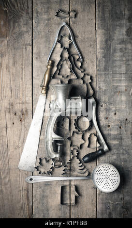 Christmas tree shape of vintage kitchen and baking utensils on a rustic wooden table, Christmas bakery concept Stock Photo