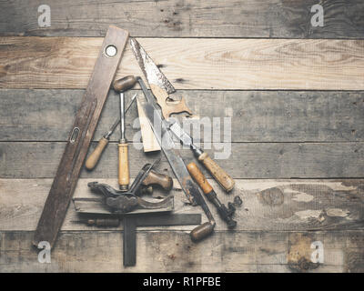Vintage carpenter tools as a Christmas tree on an old rustic wooden table with space for text on the right Stock Photo