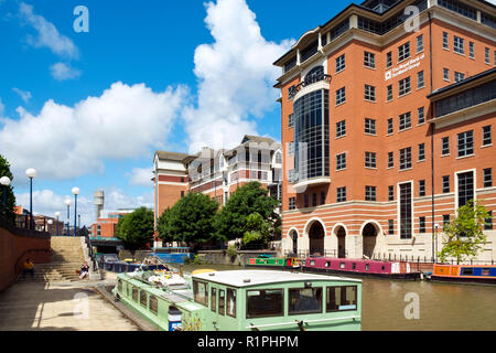 Bristol, UK - 4th August 2016: Moored canal boats and modern office blocks along The Floating Harbour and Temple Back (Temple Quay) regeneration business area in central Bristol City, UK. Workers leave their workplaces during a sunny summertime lunch break. Stock Photo