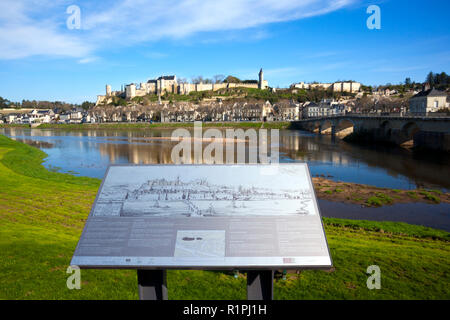 27th March 2017 - Chinon, FRance: Beautiful spring morning sunshine in Chinon town and chateau on the hill above by the banks of the Vienne River, Indre-et-Loire, France. The information board describes features of the view in several languages but has been slightly vandalised. Stock Photo