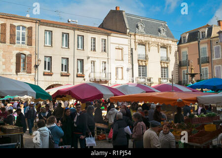 Villeneuve-sur-Lot, France - 1st April 2017: Shoppers brave a chilly spring morning at the Saturday market in Villeneuve-sur-Lot, Lot-et-Garonne, France Stock Photo