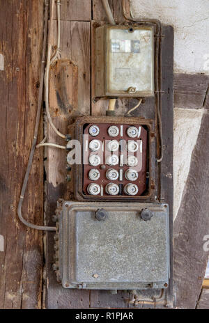 old electric cutout box on a wall in rustic ambiance Stock Photo
