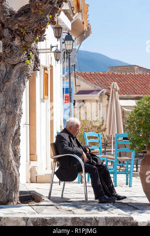 Old, local man sleeping in the sun, Omodos Square, Omodos (Troodos Mountains), Limassol District, Republic of Cyprus Stock Photo