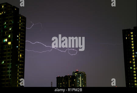 The Real Lightning Flashing on Night Sky over the High Buildings Stock Photo