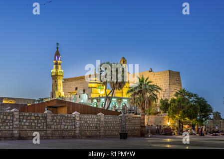 The ancient  illuminated Luxor temple at night with dark blue sky and glowing brickwalls, Luxor, Egypt, october 27, 2018 Stock Photo