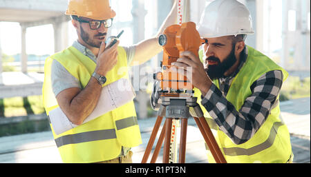 Team of architects people in group on construciton site check documents Stock Photo