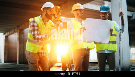 Team of construction engineers working on building site Stock Photo