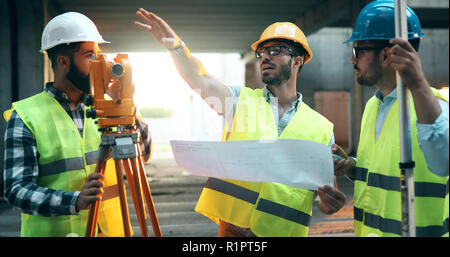 Team of construction engineers working on building site Stock Photo
