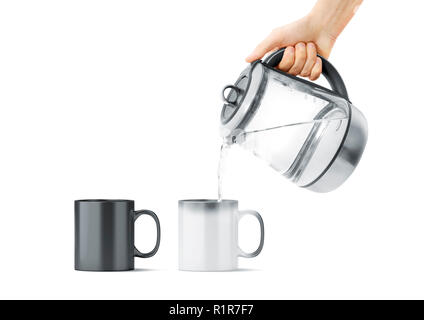 Blank black and white magic mug with hot teapot mockup, isolated. Ceramic cup filling water with kettle in hand mock up, front view. Chameleon utensil for coffee or tea with thermoprint. Stock Photo