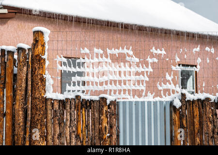 Snow covered wood; metal & fiberglass fence; 7th & Teller Streets; Salida; Colorado; USA Stock Photo