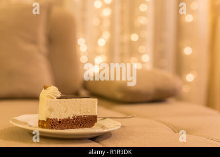 Piece of carrot homemade cake with white cream on a gray background. Festive dessert concept. Stock Photo