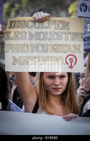A young woman is seen during the demonstration showing a sign with the text 'Sorry for the inconvenience, but they are killing us.' during the demonstration. Hundreds of student took to the streets of Barcelona during the demonstration to demand gender equality in the Education system. The students are on strike from colleges and universities to join the demonstration. Stock Photo