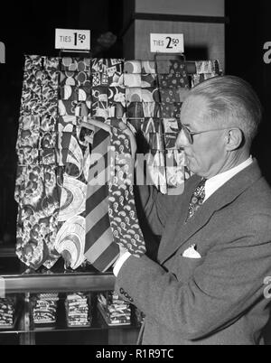 Salesman with tie display, ca. 1954. Stock Photo