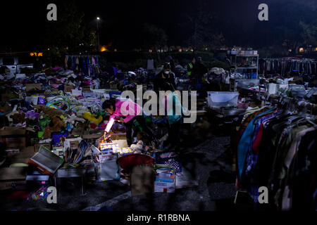 Chico, California, USA. 13th Nov, 2018. Butte Valley resident ADRIANA OROZCO, 11, searches through donations, after being evacuated from her home due to the Camp Fire, at a Walmart parking lot in Chico, California. Credit: Joel Angel Juarez/ZUMA Wire/Alamy Live News Stock Photo