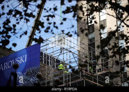 New York, USA. 14th Nov, 2018. The new Swarovski star is hoisted up to the top of the Rockefeller Center Christmas tree in New York, the United States, Nov. 14, 2018. A new star, which features 3 million Swarovski crystals on 70 illuminated spikes, was unveiled and raised to the top of the Rockefeller Center Christmas tree on Wednesday for the upcoming Christmas season. Credit: Wang Ying/Xinhua/Alamy Live News Stock Photo