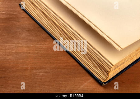 The pages of a thick old book on a dark rustic background with a place for text Stock Photo