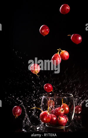 grapes fall into a glass Stock Photo