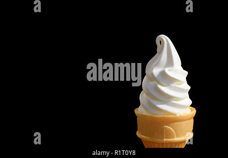 Vanilla Soft Serve Ice Cream Cone Isolated on Black Background with Free Space for Text and Design Stock Photo