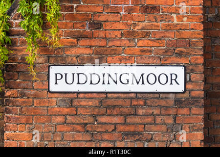 Puddingmoor an unusual road sign road name on a medieval brick wall  Beccles Suffolk England UK Europe Stock Photo