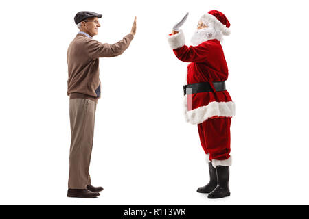 Full length profile shot of an elderly man high-fiving Santa Claus isolated on white background Stock Photo