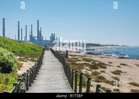 Leca da Palmeira/Porto/Portugal - 10 04 2018: View of pedestrian walkway, with people walking and resting on the wooden platform, beside the sea, back Stock Photo