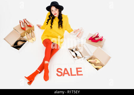beautiful stylish girl with sale symbol isolated on white with footwear Stock Photo