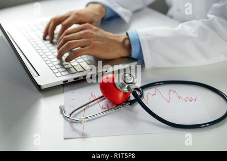 cardiology - doctor cardiologist working on laptop computer in office Stock Photo