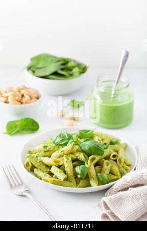 penne pasta with spinach basil pesto sauce Stock Photo