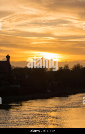 Sunset over the River Arun on a cloudy day in Autumn in Arundel, West Sussex, England, UK. Stock Photo
