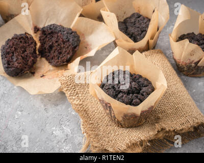Gluten-free vegan chocolate muffins with beetroot, almond powder, buckwheat flour and karob or cocoa . Burnt muffin. Homemade cupcakes on gray concrete background with copyspace Stock Photo