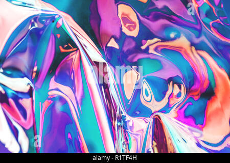 Bright holographic foil background. Multicolored and pastel trendy backdrop. Stock Photo