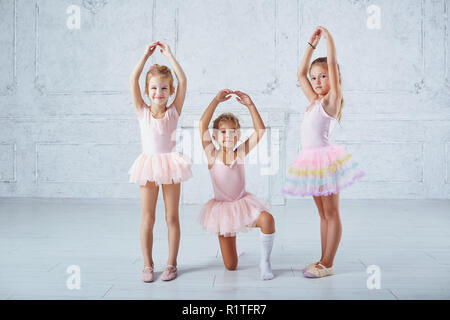 Children girls in ballerina costumes are engaged in dancing. Stock Photo