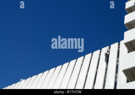 Fragment of the wall on the facade of the building.It is built in the form of parallel lines. Stock Photo