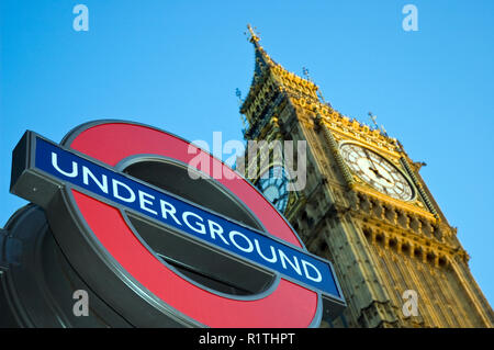 A London 'underground' station sign and 'Big Ben,' the famous neo-gothic clock and tower at the Palace of Westminster, London, England. Stock Photo