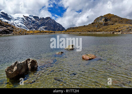Beautiful lake view in front of the snowy cochas in the Huaytapallana mountain range. Stock Photo