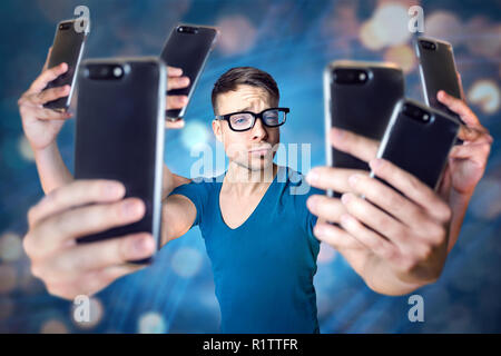 Influencer holding an exaggerated number of smartphones Stock Photo