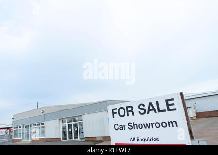 The white tiled showroom of a closed and abandoned FIAT car dealership at Old Pit Lane, Pity Me, Durham, County Durham UK Stock Photo