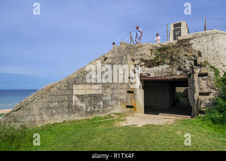 Tourists visiting the Fifth Engineer Special Brigade Memorial on top of German bunker at Omaha Beach, Colleville-sur-Mer, Calvados, Normandy, France Stock Photo