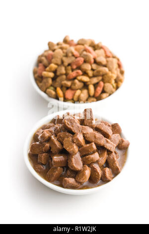 Meal for dog or cat. Canned meat with sauce and dry kibble food isolated on white background. Stock Photo