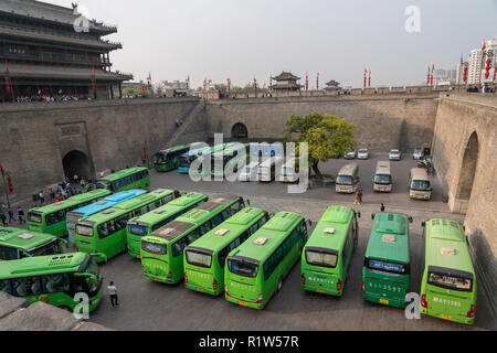 Tour buses by the city wall in Xian, China on smoggy day Stock Photo