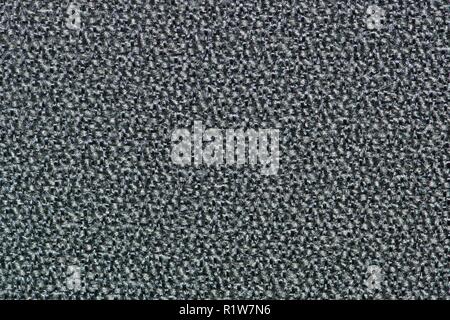 Plain swatch of black and white mottled carpet showing detailed textures. Stock Photo
