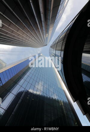 Look up next to skyscrapers with sky reflections on the tall buildings in the city of London. Modern city look. London, Undershaft, Aviva Stock Photo
