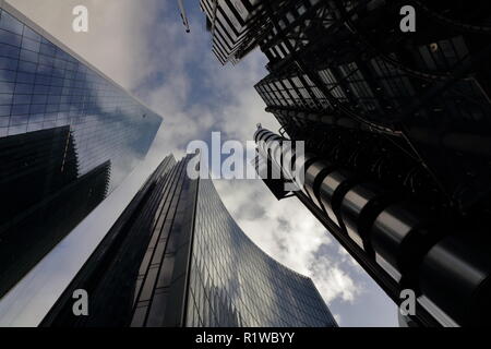 Look up next to skyscrapers with sky reflections on the tall buildings in the city of London. Modern city look. London, Undershaft, Aviva Stock Photo