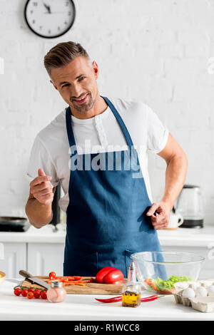 Man wearing apron cooking hi-res stock photography and images - Alamy