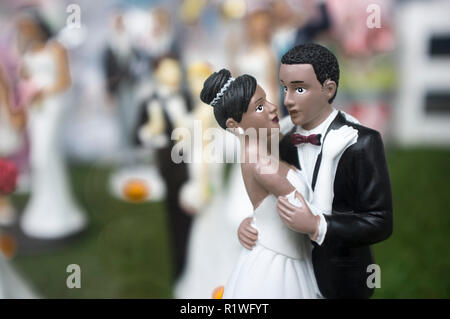 Badajoz, Spain - October 10th, 2018: Wedding cake figurine with an african american bride and bridegroom dancing. Selective focus Stock Photo