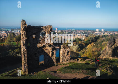 View on the old ruined chapel and city Edinburgh. The only building in the central area of Edinburgh's Holyrood Park is St Anthony's Chapel. Scotland Stock Photo