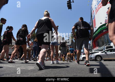 HOLLYWOOD - August 7, 2018: People crossing the road from low angle point of view on Hollywood blvd in Hollywood, CA. Stock Photo