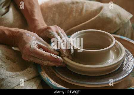 close up view of professional potter working on pottery wheel at workshop Stock Photo